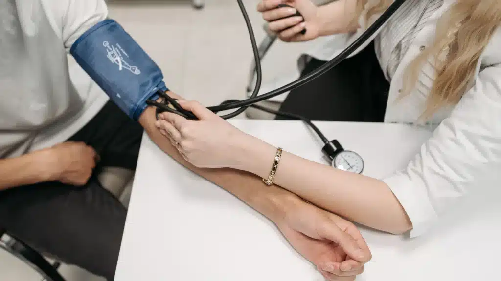 Clinician checking a patient’s blood pressure, illustrating medical monitoring during outpatient detox at Cobb Outpatient Medical Detox.